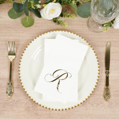 Elegant table setting with gold-accented napkin and flatware.