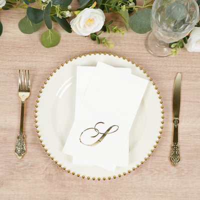 Elegant table setting with gold-accented plate and decorative napkin.