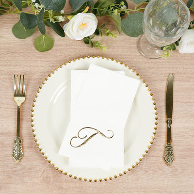 Elegant dinner setting with a gold-accented plate and folded napkin.