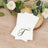 Elegant gold initial "T" on white napkins with floral decor.
