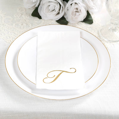 Elegant white plate with a gold-accented napkin featuring a stylized letter "T".