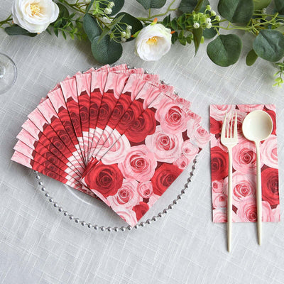 Rose-patterned paper napkins in red and pink, arranged elegantly on a table.