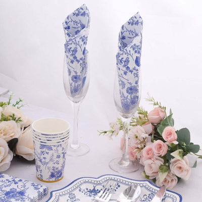 Elegant floral table setting with glassware and decorative napkins.