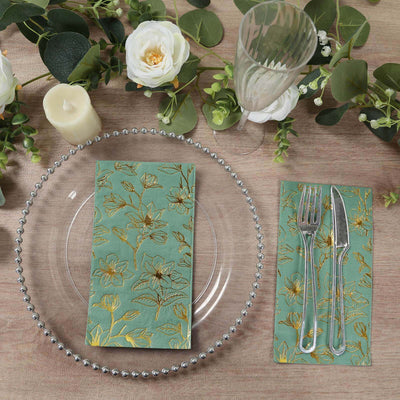 Elegant floral napkins on a styled dining table setting with cutlery and decor.