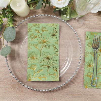 Floral patterned napkin on a decorative plate with silver beading.