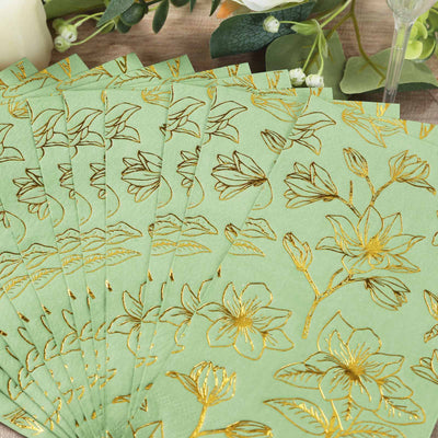 Green floral napkins with gold accents arranged in a fan shape.