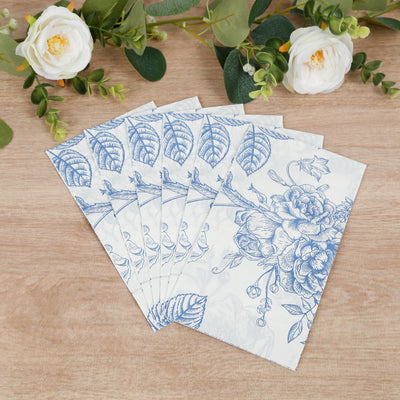 Blue floral paper napkins arranged on a wooden surface.