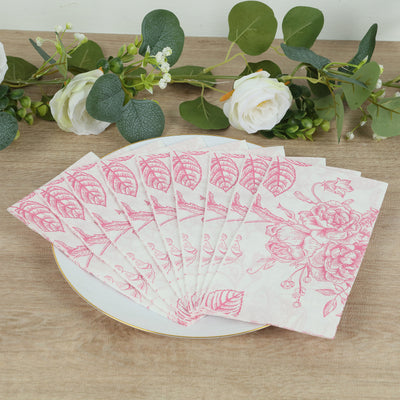 Floral patterned paper napkins stacked on a plate with greenery and flowers.