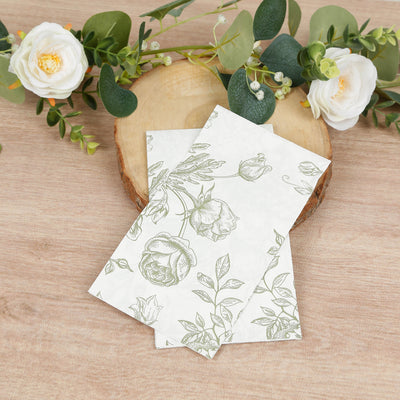 Floral illustrated notecards on a wooden surface with greenery accents.