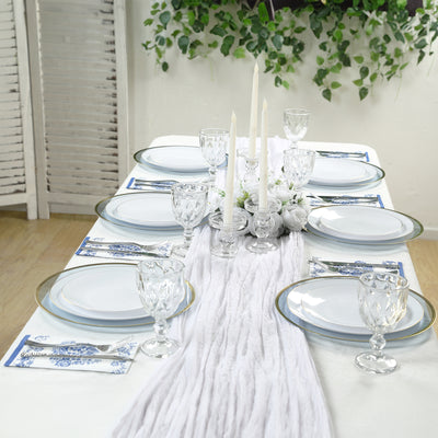 Elegant dining table set with plates, glasses, and candles for a stylish meal.