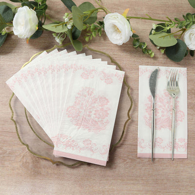 Elegant pink floral patterned napkins arranged on a decorative plate.