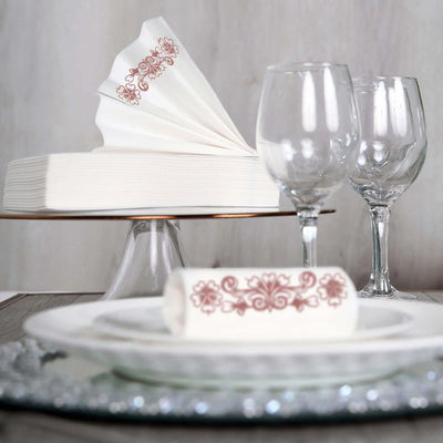 Elegant table setting with decorative napkins and wine glasses.