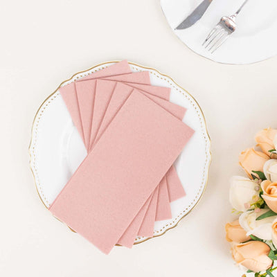 Set of pink envelopes on a decorative plate with flowers.