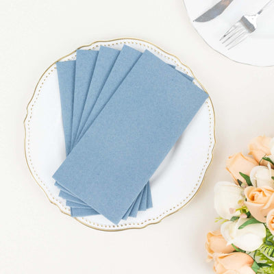 Blue paper napkins arranged on a decorative plate with flowers.