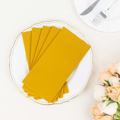Yellow envelope sets on a decorative plate with flowers in the background.