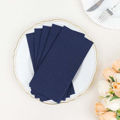 Navy blue napkins on an elegant plate with floral accents.