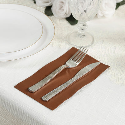 Elegant brown cutlery holder with fork and knife on a decorated table setting.