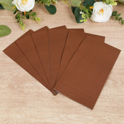 Set of six brown envelopes on a wooden surface.