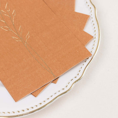 Elegant brown stationery with floral design on a decorative plate.