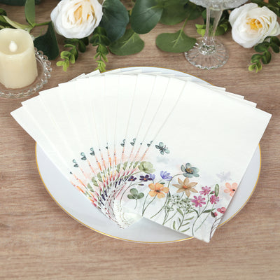 Floral-themed paper napkins arranged on a decorative plate.