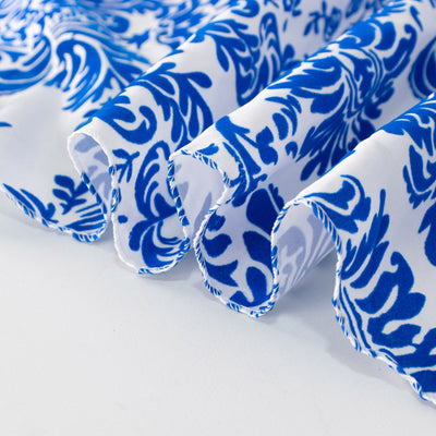 Blue floral patterned fabric with flowing edges.