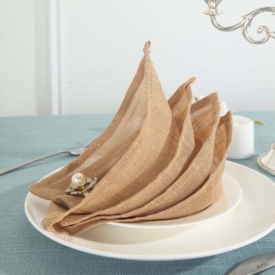 Elegant brown linen napkins arranged in a stylish fold on a plate.