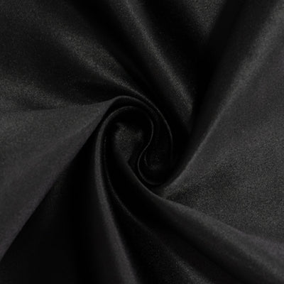 Black satin fabric close-up showing smooth texture and sheen.