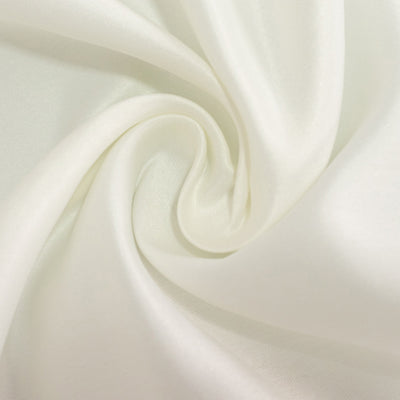 Soft white fabric texture in a swirling pattern.