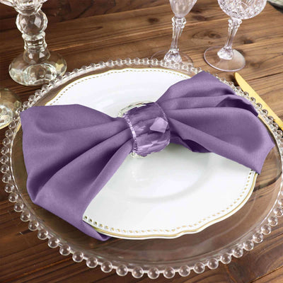 Purple satin napkin elegantly styled on a decorative plate.