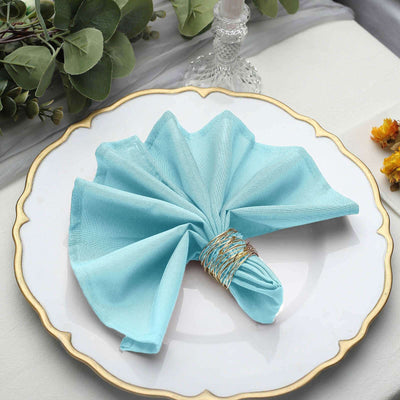 Blue cloth napkin elegantly styled on a decorative plate.
