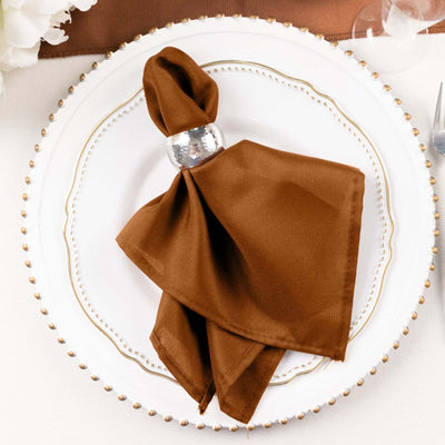 Brown napkin elegantly styled on a decorative plate.