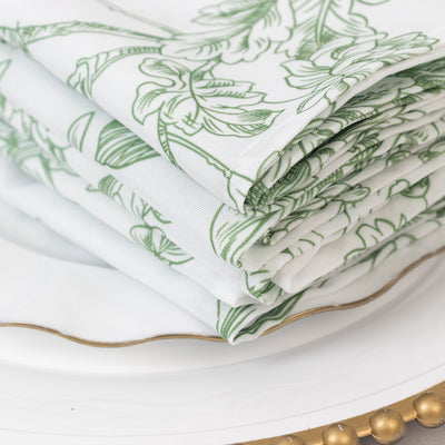 Stack of floral-patterned napkins on a decorative plate.