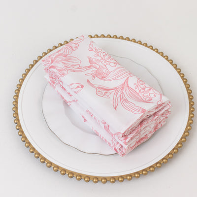 Floral patterned napkins stacked on a decorative plate.