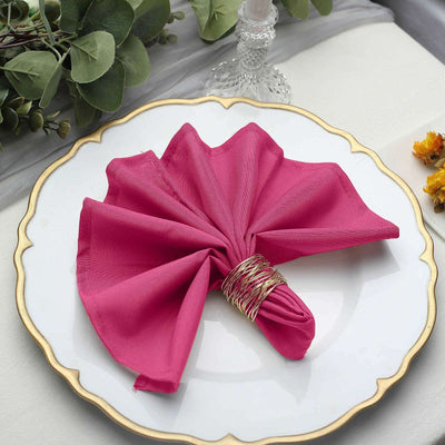 Pink napkin elegantly folded on a decorative plate.