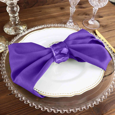 Purple silk napkin elegantly styled on a decorative plate.