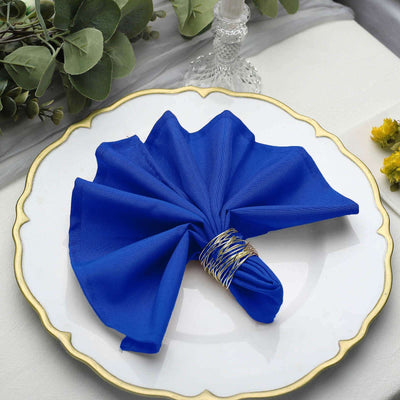 Elegant blue napkin elegantly displayed on a decorative white plate.