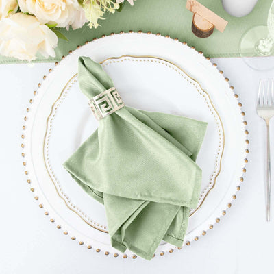 Green napkin with decorative ring on an elegant plate setting
