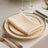 Elegant cream napkin on an ornate dinner plate setting.