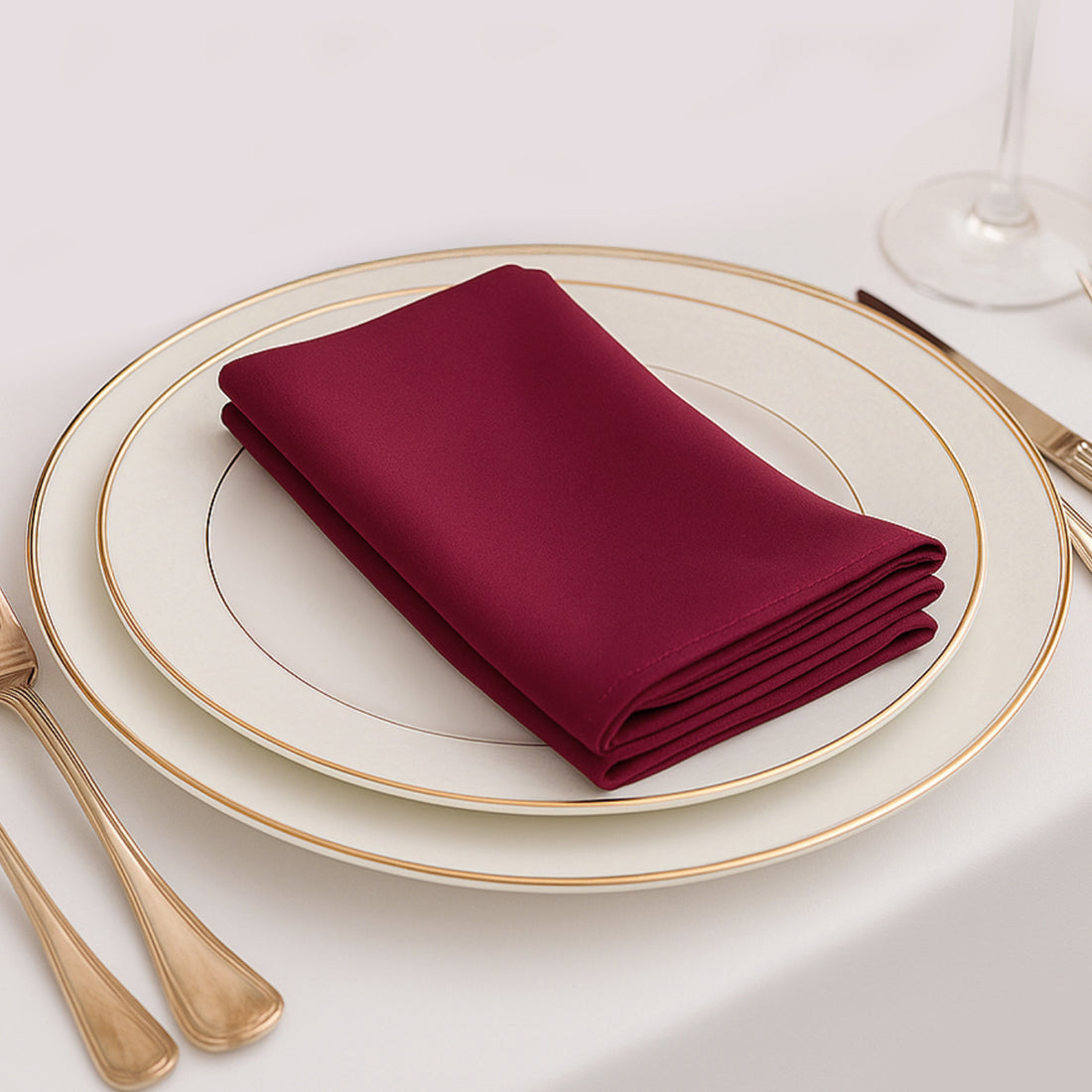 Burgundy napkin elegantly folded on a fine dining plate