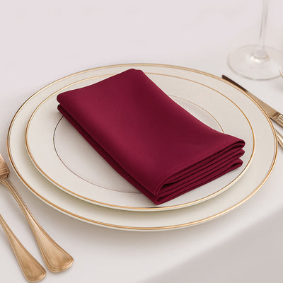 Burgundy napkin elegantly folded on a fine dining plate
