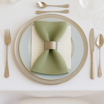 Elegant table setting with a green napkin and silver cutlery.