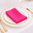 Pink napkin elegantly folded on a white plate with gold trim.