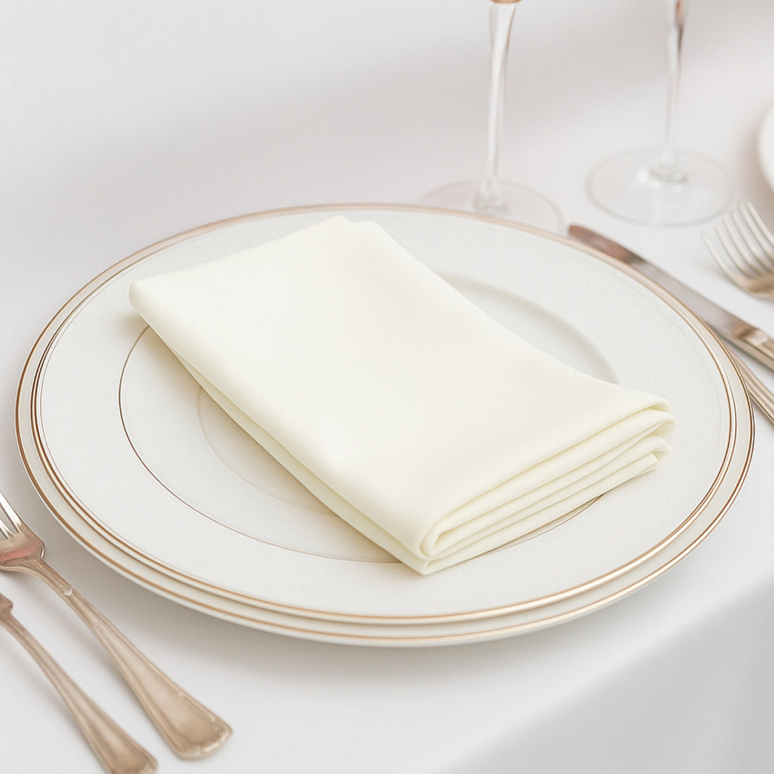 Elegant cream napkin neatly folded on a decorative plate.
