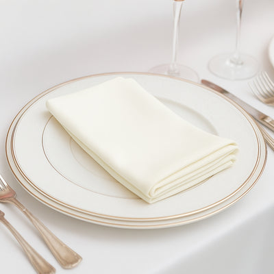 Elegant cream napkin neatly folded on a decorative plate.
