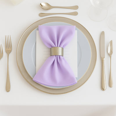 Lavender napkin with silver holder on elegant dining plate setting