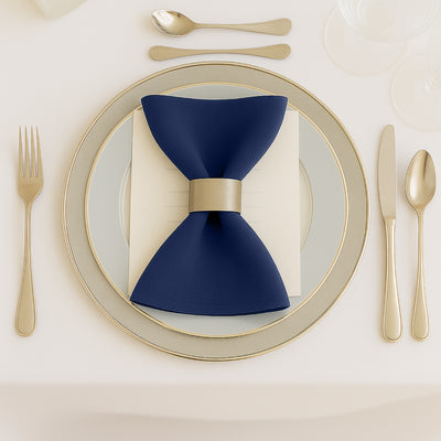 Elegant navy bow tie napkin on a beautifully set dining table.