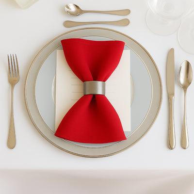 Elegant red napkin tied with a silver ring on a stylish dinner plate