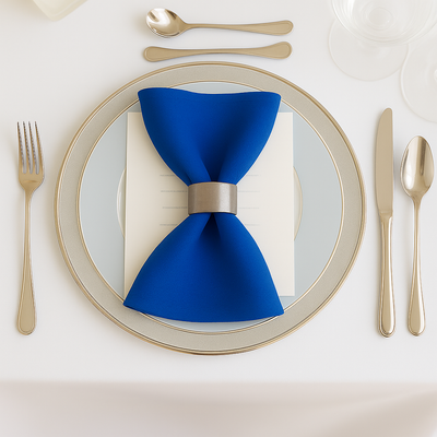 Elegant blue napkin with silver ring on a fine dining plate setting.
