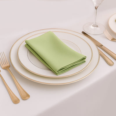 Green napkin elegantly folded on a white plate with gold trim.