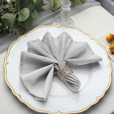 Elegant gray napkin beautifully arranged on a decorative plate.